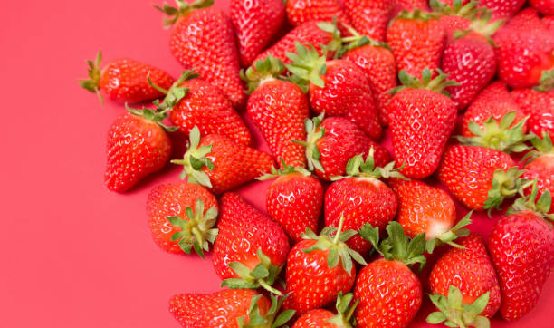 istock Ripe juicy orgaic strawberries on a red background. 1224962062