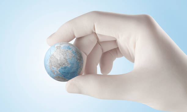 istock Pandemic concept. Hand holding the earth. 1224965275