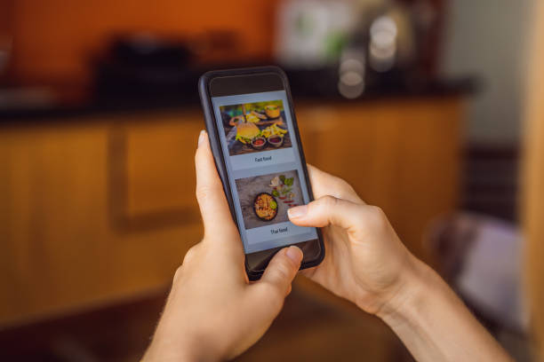 istock Young woman orders food for lunch online using a smartphone 1224965633