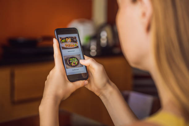 istock Young woman orders food for lunch online using a smartphone 1224965636
