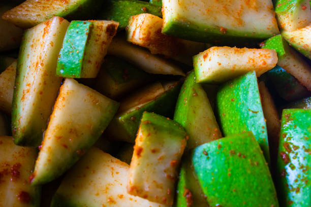 Raw mango cut into small pieces mixed with salt and red chili pepper
