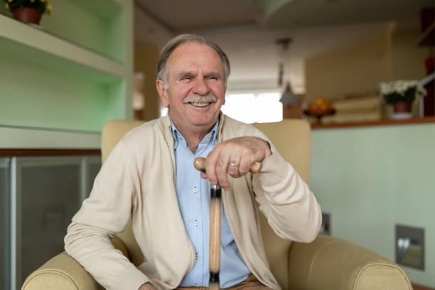 istock Senior Man is Sitting at Home in Deep Thoughts and Smiling. 1224966635