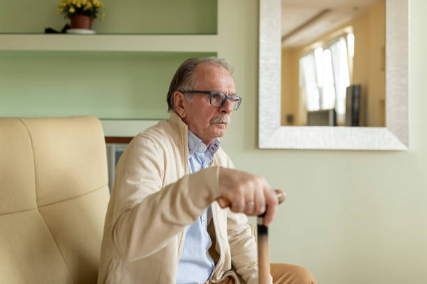 istock Lonely Senior Man is Sitting on Sofa at Home and Looking Sad. 1224966697