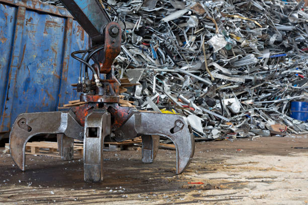 istock Used metal pieces on a scrap yard with large grabber 1224966921