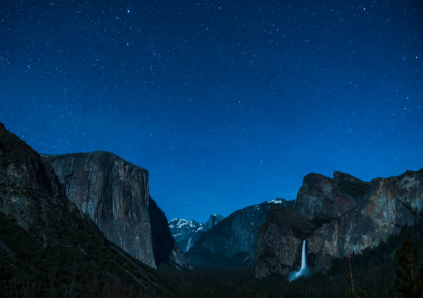 istock yosemite at night with star night sky background. 1224967611