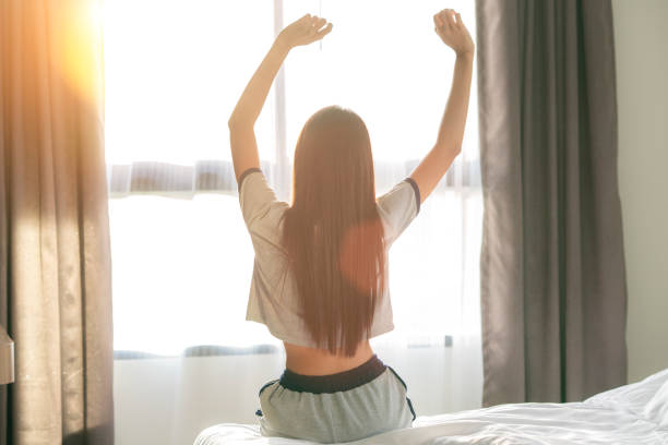 istock Asian Woman stretching in bed after wake up 1224971752