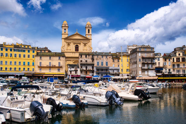 vieuw on église Saint Jean-Baptiste in Bastia from the vieux port with some boats resting in the habour during summertime