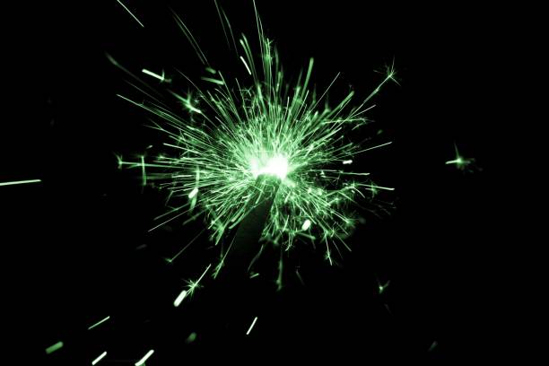 istock Green sparkler countdown on fire with spread of glitter sparks 1224975250