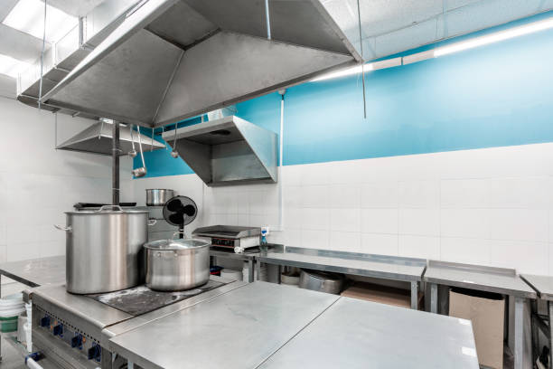 istock Work surface and kitchen equipment in professional kitchen. Cooking with preparation tables, pans, pots, stoves. 1224975776