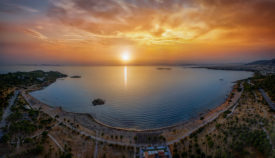 Aerial panorama of the beautiful beach of Kavouri, Vouliagmeni disctrict of south Athens and part of the Riviera during sunset time, Greece