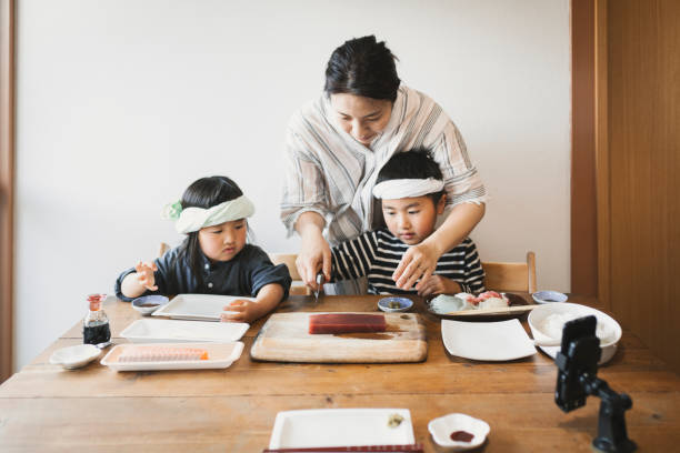 istock Siblings cooking sushi at home for video streaming 1224977785