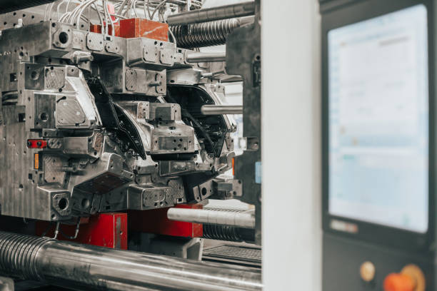 istock Huge injection molding machine without fixture  ready for the plastic articles by injecting heated material into mold 1224978073
