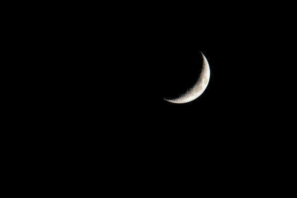 istock young moon on black background - Waxing Crescent 1224979673