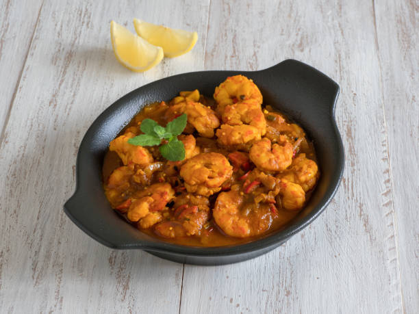 istock Prawns in curry sauce in a black pan close-up 1224979768