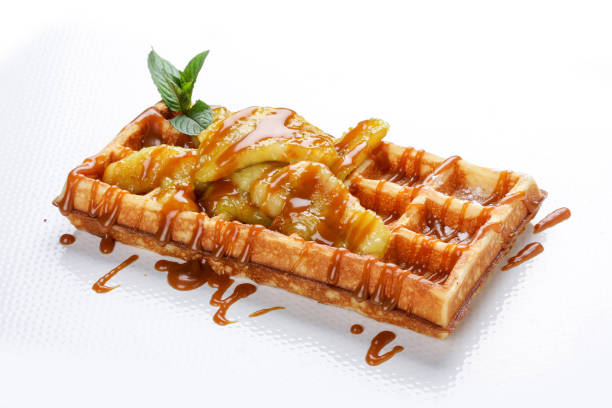 istock Belgian sweet waffles on a white background. Stuffed with apples, caramel syrup under 1224979783