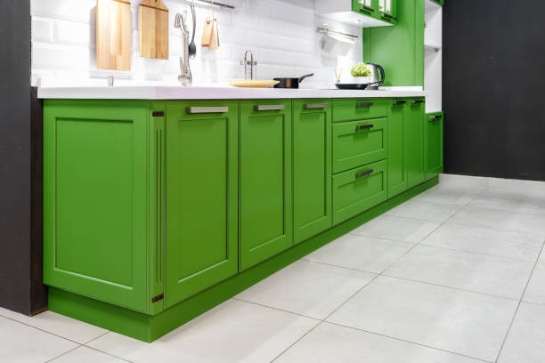 istock Classic kitchen interior with green trim. Kitchen acrylic countertop with built-in sink. 1224979890