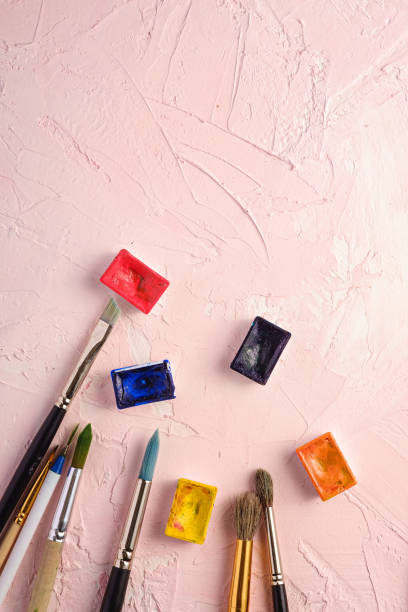 istock Paint brushes, artist tools for drawing on textured pink background, top view, copy space 1224983610