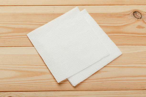 istock white paper napkin or tissue on the wooden table background. 1224983865