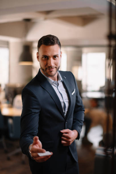 istock Handsome businessman giving a handshake in office 1224985682