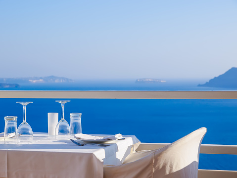 Open restaurant terrace with amazing sea view on Santorini island. Cyclades, Greece