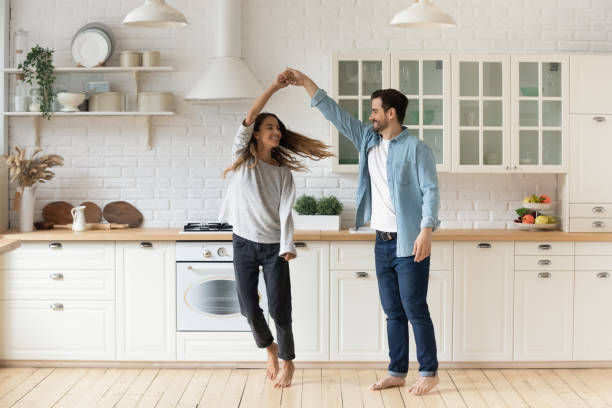 istock Happy loving couple having fun in kitchen, dancing together 1224986937