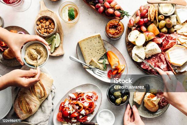 Women Eating Fresh Mediterranean Platter On Table Stock Photo - Download Image Now - Food, Table, Eating