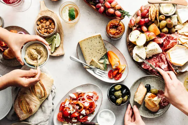 Photo of Women eating fresh Mediterranean platter on table