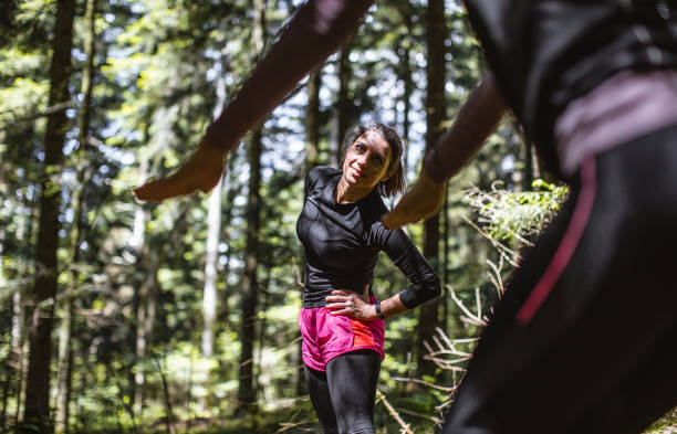 istock Two women exercising in the woods 1224987611