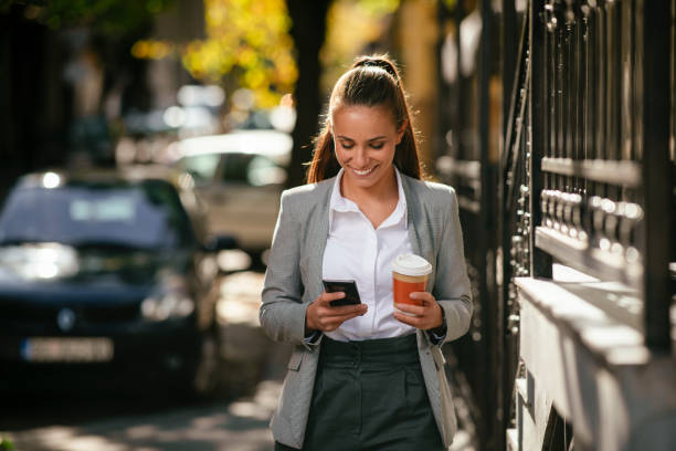 istock Young businesswoman drinking coffee and using the phone. 1224988547