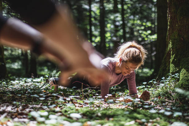 istock Woman doing a plank in the woods 1224988557