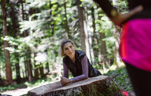 istock Two women exercising in the woods 1224988561