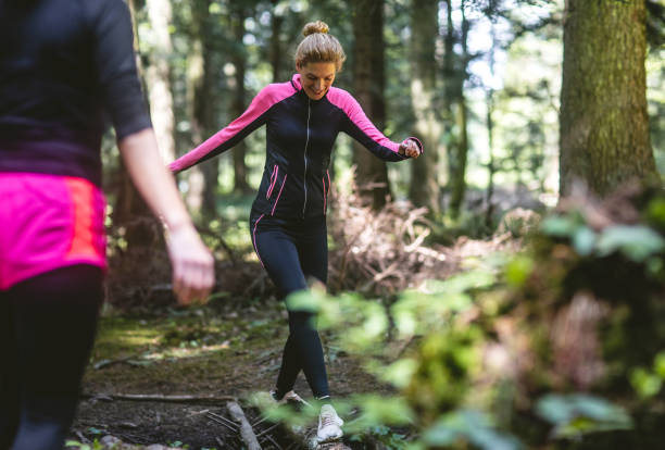 istock Two women exercising in the woods 1224989052