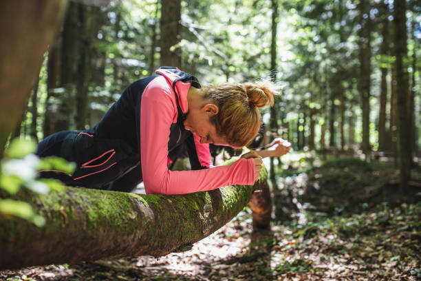 istock Two women exercising in the woods, doing a plank 1224990029