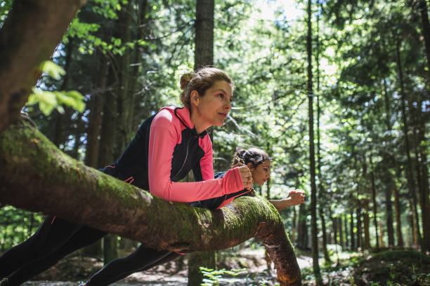 istock Two women exercising in the woods, doing a plank 1224990637