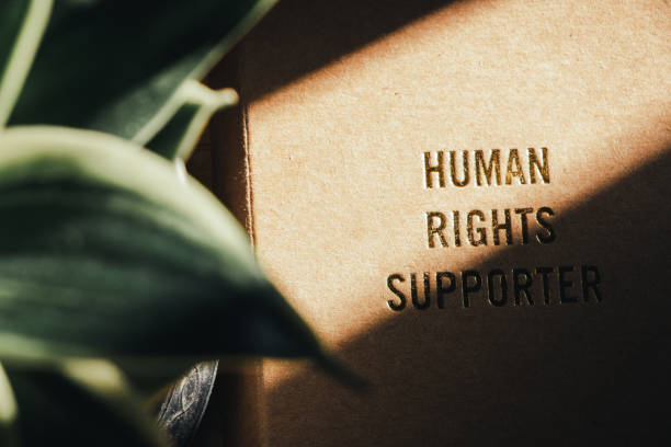 istock human rights concept. human rights text on cover note book with light of sun feel hopeful. 1224992341
