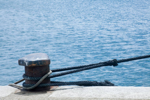 istock Harbor mooring post, thick ropes, sea background. 1224995909