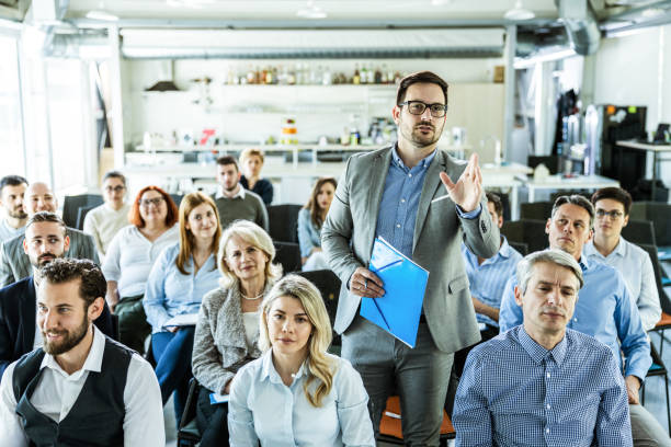 istock Young businessman talking on a seminar in board room. 1224998485
