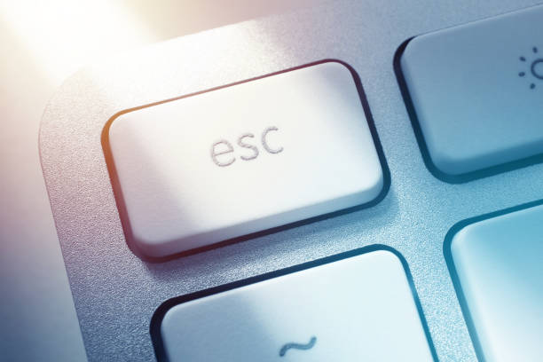 Close-up on Escape Key of Computer Keyboard Close-up on Escape Key of Computer Keyboard. escape key escape computer push button stock pictures, royalty-free photos & images