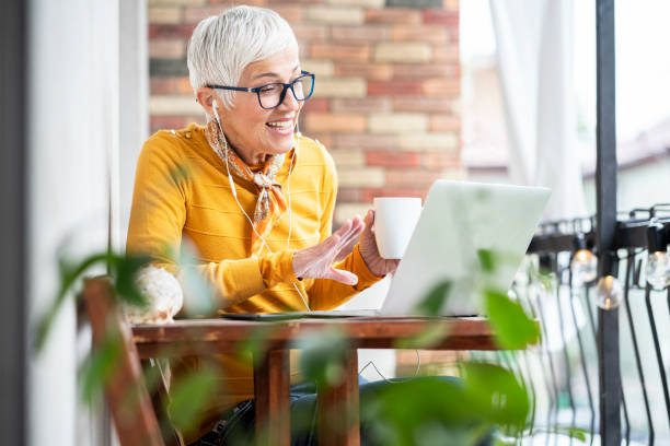 istock Mature woman on balcony working at home office 1225001142