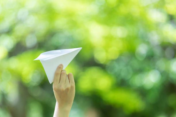 istock Young woman lady with handmade paper plane 1225001289