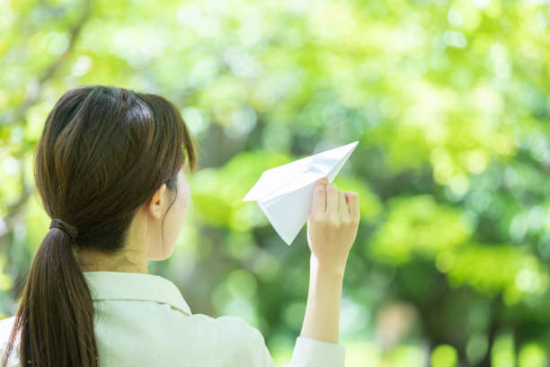 istock Young woman lady with handmade paper plane 1225001317