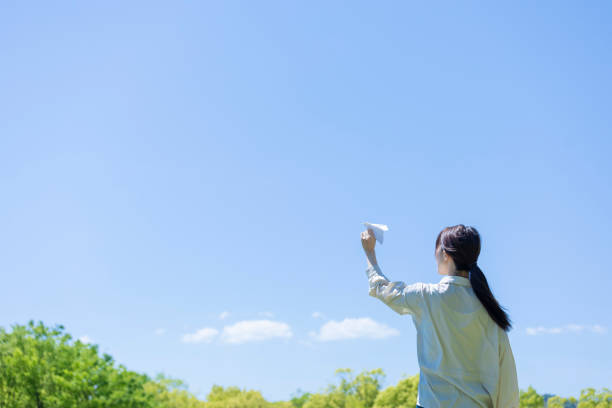 istock Young woman lady with handmade paper plane 1225002023