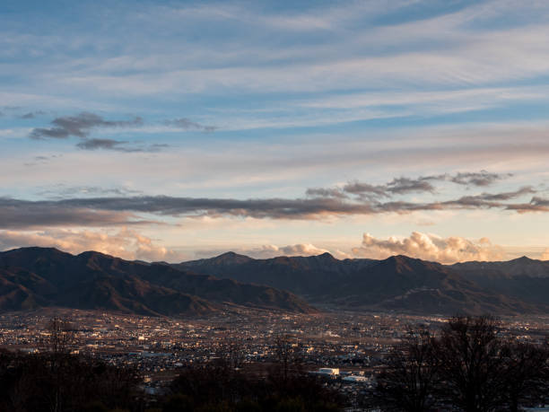 istock Kofu city in the evening surrounded by mountains 1225002312