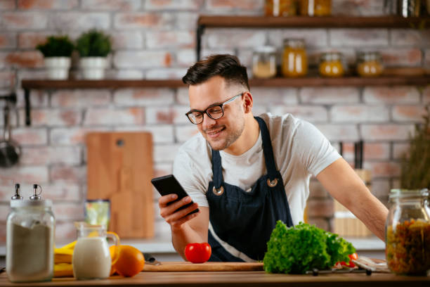 istock Handsome man making delicious food in kitchen. 1225002510