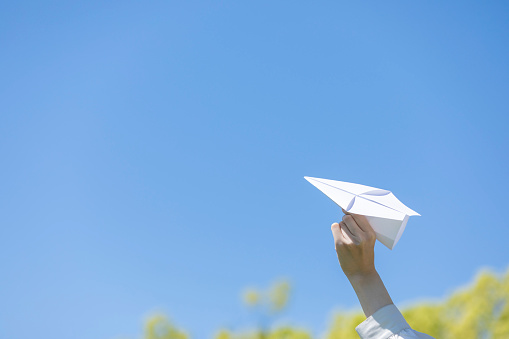Young woman lady with handmade paper plane