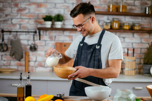 istock Handsome man making delicious food in kitchen. 1225002593