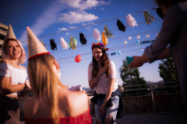 istock Four young Caucasian people partying on the rooftop 1225004595
