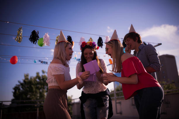 istock Four young Caucasian people partying on the rooftop 1225004629