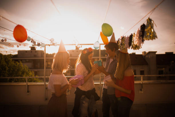 istock Group of young people partying on the rooftop 1225005905