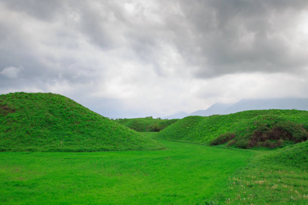 istock Landscape summer and spring. Bright green grass on the round hills. Clouds before the rain. Clouds in the sky. Tourism travel. 1225007086